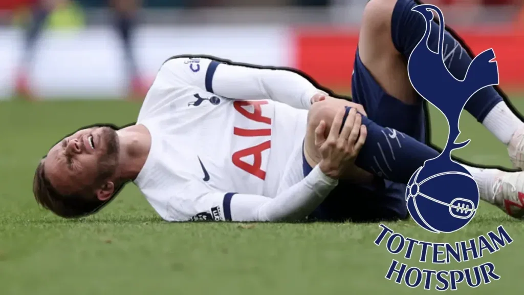 Tottenham's James Maddison cutches his injured knee
